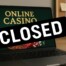 Laptop displaying online casino with CLOSED sign representing Golden Billy Casino shutdown