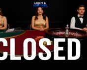 Light and Wonder live casino dealers at closed gaming tables with roulette wheel and card games