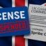 UK Gambling Commission suspends Spribe OÜ license with red suspended stamp over blue license card against Union Jack flag background