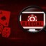 Magnifying glass examining computer monitor displaying illegal gambling site with casino chips, dice and playing cards in red tones