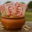 New Zealand currency in clay pot representing community funding from online casino gambling revenue