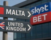 Directional signs showing Malta and United Kingdom with SkyBet logo representing gambling operator's relocation from UK to Malta
